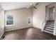 Spacious living room with hardwood floors, high vaulted ceilings, and a staircase to the upper level at 3844 S Gibralter St, Aurora, CO 80013
