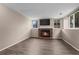 Inviting living room with a brick fireplace, sleek mounted TV, and natural light streaming through the windows at 3844 S Gibralter St, Aurora, CO 80013