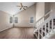 Living room featuring hardwood floors, vaulted ceilings, a ceiling fan, and staircase to the upper level at 3844 S Gibralter St, Aurora, CO 80013