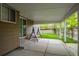 A covered patio area with a swing and concrete flooring, offering an outdoor living space at 3844 S Gibralter St, Aurora, CO 80013