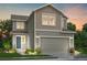 Charming two-story home with a craftsman-style garage, neutral siding, and professional landscaping at 9092 Quintero St, Commerce City, CO 80022