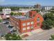 Aerial view of a loft conversion in a brick building, showcasing urban surroundings and parking at 225 N Lincoln St # 4, Denver, CO 80203
