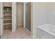 Bright bathroom with a tub, shower, and convenient shelving for storage at 225 N Lincoln St # 4, Denver, CO 80203