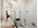 Bathroom features a tub with shower, toilet, and sink with a tile countertop at 225 N Lincoln St # 4, Denver, CO 80203