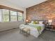 Stylish bedroom with exposed brick wall, creating a cozy and inviting atmosphere at 225 N Lincoln St # 4, Denver, CO 80203