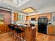 Modern kitchen in loft with granite countertops, a breakfast bar, black appliances, and hardwood floors at 225 N Lincoln St # 4, Denver, CO 80203