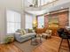 Stylish loft living room features hardwood floors, a comfortable seating area, and exposed brick at 225 N Lincoln St # 4, Denver, CO 80203