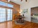 Office with exposed brick wall, wood floors, french doors, and desk at 225 N Lincoln St # 4, Denver, CO 80203