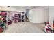Finished basement with gray carpet and shelving and staircase at 2482 Purcell Pl, Brighton, CO 80601