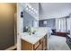 Bright bathroom featuring a modern vanity, updated fixtures, and convenient access to the main bedroom at 2482 Purcell Pl, Brighton, CO 80601