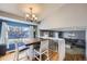 Cozy dining area featuring a rustic table, bright natural light, and an open concept layout at 2482 Purcell Pl, Brighton, CO 80601
