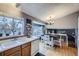 Bright kitchen and dining area featuring hardwood floors and a view to the home's second level at 2482 Purcell Pl, Brighton, CO 80601