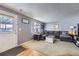 Comfortable living room with plush gray sectional, neutral carpet, and natural light from the window at 2482 Purcell Pl, Brighton, CO 80601