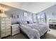 Serene main bedroom boasts vaulted ceilings, ample natural light, and soothing color palette at 2482 Purcell Pl, Brighton, CO 80601