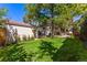 Spacious backyard showcasing landscaping, green lawn and a garage at 1035 S Elizabeth St, Denver, CO 80209