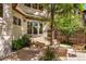 Relaxing backyard patio area with wicker furniture, surrounded by trees and privacy fence at 1035 S Elizabeth St, Denver, CO 80209
