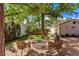 Backyard patio featuring lounge chairs, fire pit, landscaping, and grass at 1035 S Elizabeth St, Denver, CO 80209