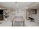 Finished basement features ping pong table, weight bench, and large potted plant at 1035 S Elizabeth St, Denver, CO 80209