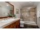 Bathroom featuring tiled shower with glass doors, vanity, and natural light at 1035 S Elizabeth St, Denver, CO 80209