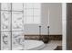 Bathroom with a soaking tub, tile accents, decorative candle sticks, and privacy window blocks at 1035 S Elizabeth St, Denver, CO 80209
