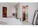 Bedroom with multiple doorways, en suite bathroom, and modern decor at 1035 S Elizabeth St, Denver, CO 80209