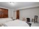 Bright bedroom with hardwood doors, neutral walls, and an open door at 1035 S Elizabeth St, Denver, CO 80209
