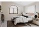 Cozy bedroom with a large arched window, a comfortable bed, and soft lighting, offering a serene retreat at 1035 S Elizabeth St, Denver, CO 80209