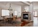 Elegant dining room with a round table, stylish chairs, modern lighting, and a cozy fireplace at 1035 S Elizabeth St, Denver, CO 80209