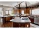 Well-lit kitchen with stainless steel appliances, wood cabinets, and hardwood floors at 1035 S Elizabeth St, Denver, CO 80209