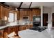 Well-equipped kitchen showcasing custom cabinets, granite counters, modern appliances, and a gas stovetop at 1035 S Elizabeth St, Denver, CO 80209