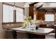 Kitchen area with a stone countertops, wood cabinets and large window for natural light at 1035 S Elizabeth St, Denver, CO 80209