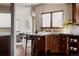 Stylish kitchen featuring wooden cabinets, granite countertops, stainless steel sink, and modern lighting at 1035 S Elizabeth St, Denver, CO 80209