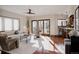 Bright and airy living room with hardwood floors, stylish furnishings, and a view to the backyard at 1035 S Elizabeth St, Denver, CO 80209