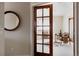 Bright living room featuring a glass door, a round mirror, and stylish decor creating a relaxing ambiance at 1035 S Elizabeth St, Denver, CO 80209