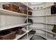 Organized pantry with white shelving, woven baskets, and a variety of storage options for a clutter-free kitchen at 1035 S Elizabeth St, Denver, CO 80209