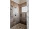 Bathroom shower features dual shower heads, stone-look tile walls, and a glass block window at 1035 S Elizabeth St, Denver, CO 80209