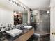 Modern bathroom with dual vanity sinks, a glass-enclosed shower, and sleek fixtures at 1747 N Pearl St # 306, Denver, CO 80203