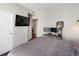 Bedroom setup with desk, closet access, and a view of a modern exterior at 1747 N Pearl St # 306, Denver, CO 80203