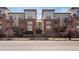 Inviting brick apartment building featuring balconies, mature trees, and attractive architectural details at 1747 N Pearl St # 306, Denver, CO 80203