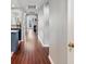 Hallway with hardwood floors, leading to the kitchen and living areas at 1747 N Pearl St # 306, Denver, CO 80203