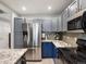 Stylish kitchen with stainless steel refrigerator, granite countertops and designer backsplash tiles at 1747 N Pearl St # 306, Denver, CO 80203