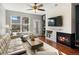 Contemporary living room with a fireplace, large window, and access to a balcony with city views at 1747 N Pearl St # 306, Denver, CO 80203