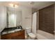 Bathroom with dark brown vanity, shower/tub combo, and tile at 891 14Th St # 1006, Denver, CO 80202