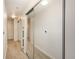 Hallway with mirrored closet doors and neutral wall colors at 891 14Th St # 1006, Denver, CO 80202