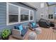 Inviting back porch with comfortable seating, decorative pillows, and a modern grill at 1168 Basalt Ridge Loop, Castle Rock, CO 80108