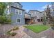 Serene backyard featuring a plush lawn, decorative rock, a privacy fence, and steps to an elevated porch at 1168 Basalt Ridge Loop, Castle Rock, CO 80108