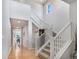 Bright entryway with soaring ceilings, hardwood floors and a staircase with white railings at 1168 Basalt Ridge Loop, Castle Rock, CO 80108