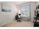 Carpeted home office features neutral walls, a window with blinds, desk, black filing cabinet, and decor at 1168 Basalt Ridge Loop, Castle Rock, CO 80108