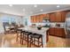 Open kitchen featuring an island with bar seating, stainless appliances, and a dining area at 1168 Basalt Ridge Loop, Castle Rock, CO 80108