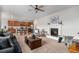 Open concept living room featuring a cozy fireplace and a seamless flow into the kitchen at 1168 Basalt Ridge Loop, Castle Rock, CO 80108